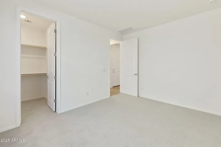 HALL BEDROOM WITH LARGE WALK IN CLOSET.