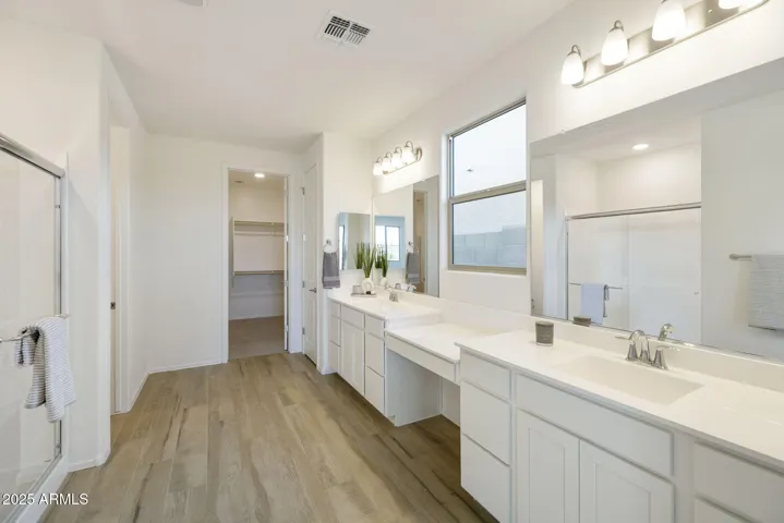 OWNER'S BATH WITH DUAL VANITIES, SHOWER AND KNEE SPACE.