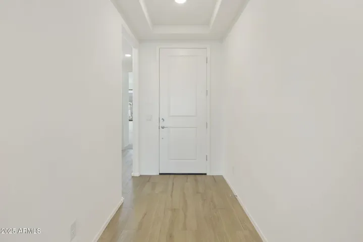 WOOD PLANK TILE FLOORING THROUGHOUT. FOYER HAS COFFERED CEILING.