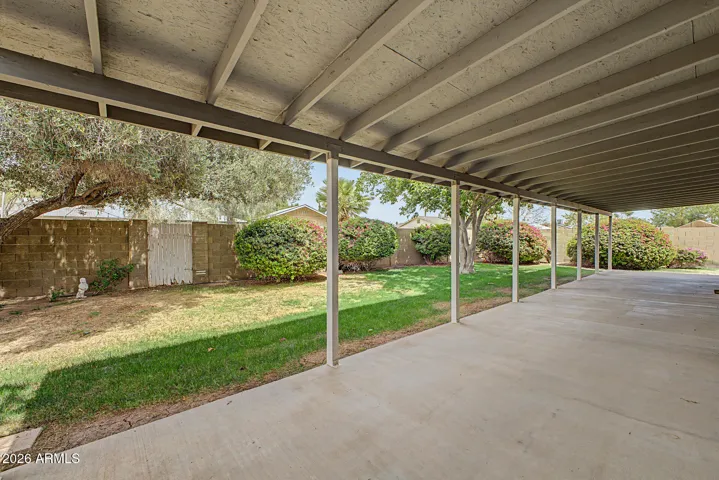 Good size covered cement backyard patio