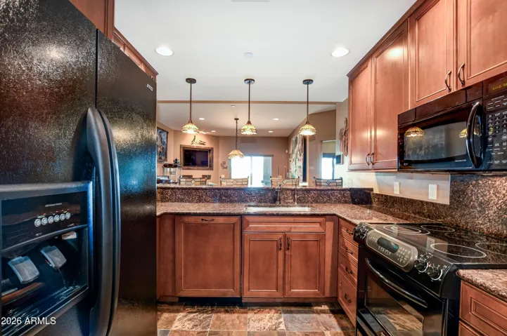 Equipped with Refrigerator, electric range, microwave, wine fridge, Pendant lighting, granite countertops