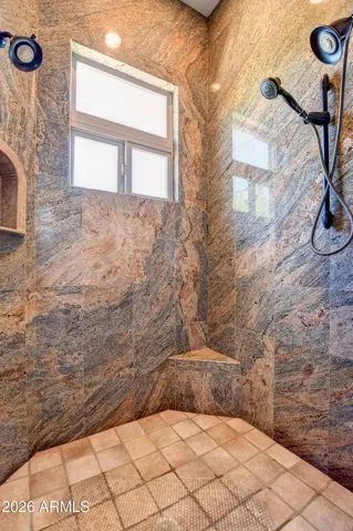 Granite Tile from flooring to ceiling, Corner Shower Stool, Dual Shower Heads, Carved Travertine Shower Niches, Obscure Window for Natural Lighting