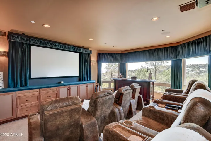 Plush, comfortable 8 chair seating, custom-designed recliners with built-in cup holders and tray for your favorite snac