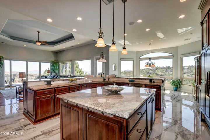 Pendant lighting and expansive windows to allow natural light and the serene landscape of the outdoors