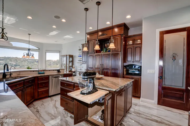 A dream kitchen with built in features in almost every cabinet and drawer for the ultimate chef's kitchen