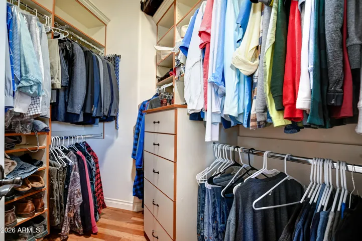 His closet with custom built in organization and a built-in steamer so you always look your best