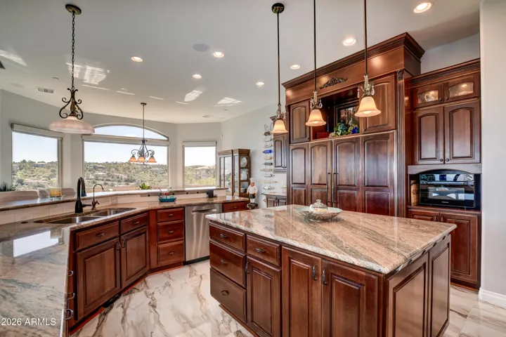 Custom cherry cabinetry with rope inlay, crown molding, staggered heights and rain glass upper lighted cabinets
