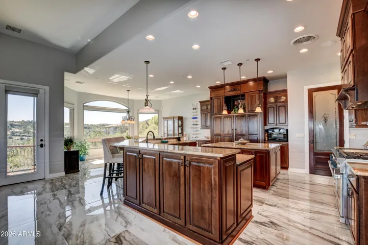 Every detail for family and entertaining resonate in this gourmet kitchen. Highlighted with ceramic marble look flooring