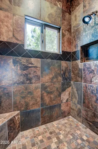 Large Walk in Slate tile Shower with Black Diamond Accents, Corner Shower Stool, Window for natural Lighting