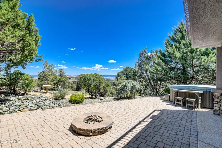 Pavers adorn the open patio space that enhances the serene surrounding environment