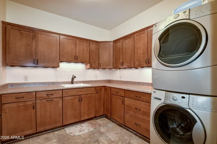 Pecan Cabinets, Large Soaking sink with jets, Stackable washer and dryer, Drawer pullout ironing board, and pull out drying rack