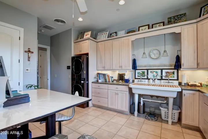 Abundance of Cabinets, walk in closet, Large freestanding sink with 2 faucets and a drying wood rack that fits on top, full size stackable washer and dryer