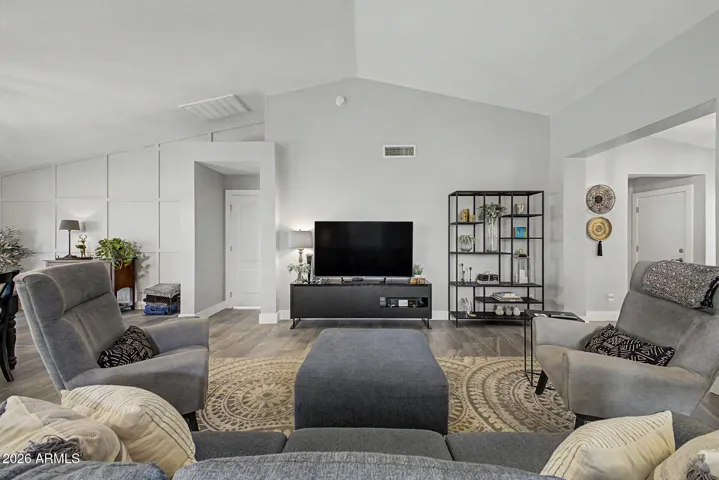 Inviting living space centered around a comfortable seating area and media wall.