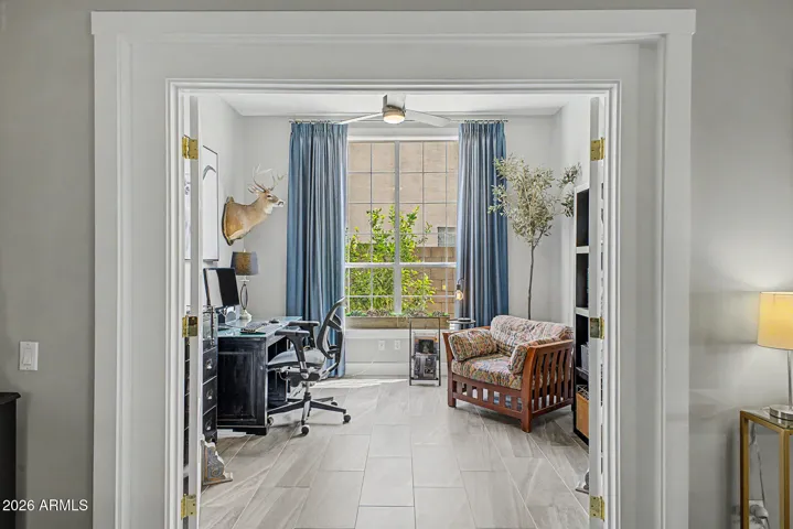 Private office or den with newer dual glass doors and natural light.