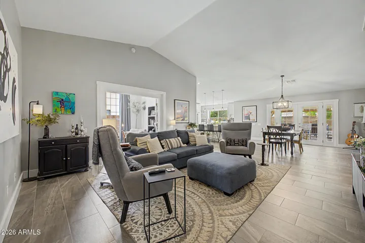 Open concept living area with seamless flow into the dining and kitchen.