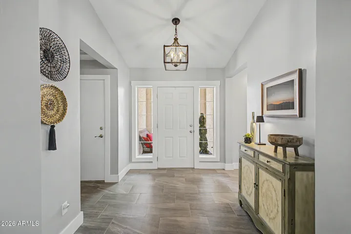 Bright entryway with front door and sidelights bringing in natural light.