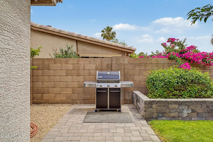 Paver walkway along the side of the home leads to citrus trees, lemon, lime and grapfruit.