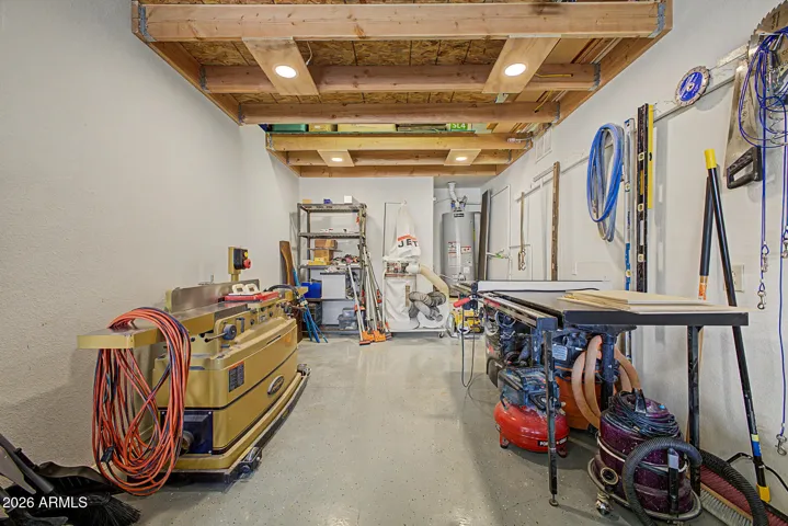 Extended garage space features a functional workshop setup with built-in overhead storage, maximizing organization and usability.