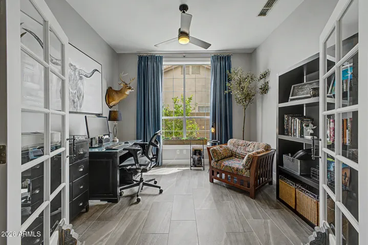 Comfortable office/den with dedicated work area and cozy seating space.