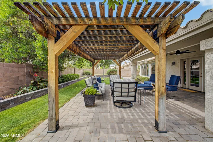 Inviting covered seating area overlooking the yard, perfect for relaxing or gathering with friends and family.