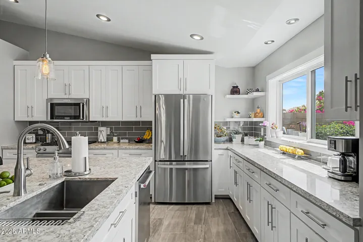 Large picture window over sink brings in natural light and views of backyard