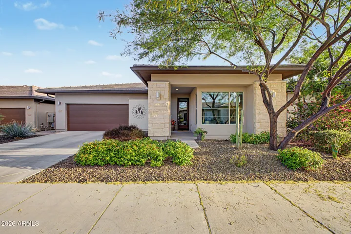 Beautifully landscaped front yard is maintained by the HOA