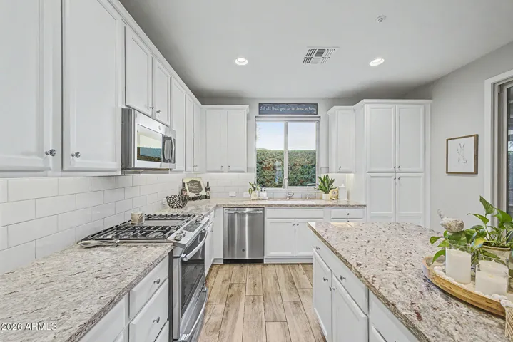 Upgraded stainless steel appliances: Slide in over with gas cook top & griddle. Kitchen sink overlooks private rear yard