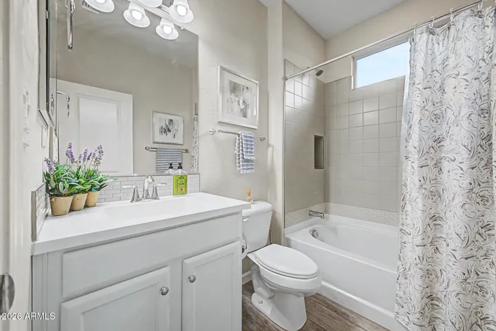 Guest bath with cultured marble c-top, tile b-splash, upgraded tile in shower/tub combo