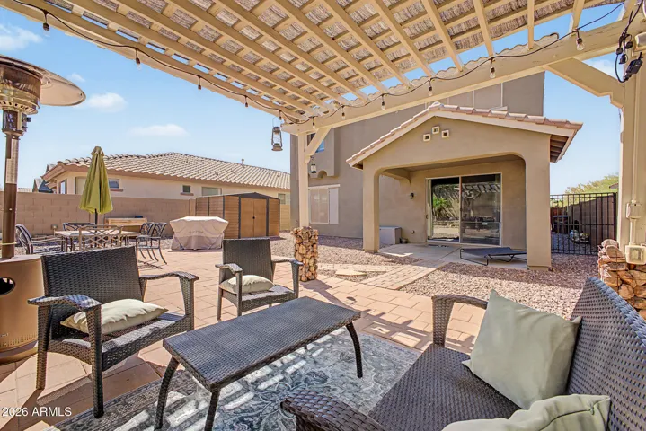 Custom pergola adds shade and while enjoying the backyard.