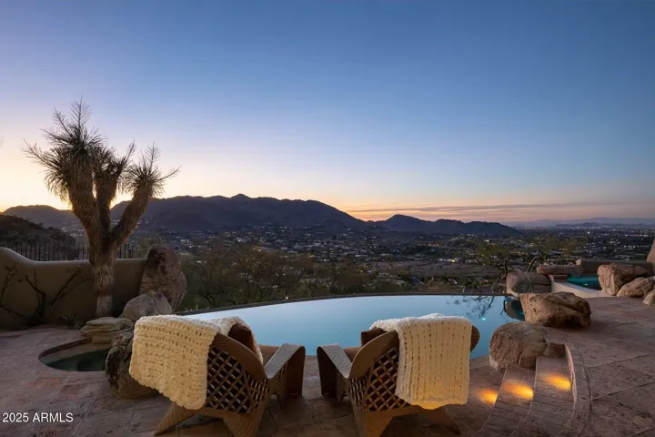 Positioned for nightly golden hour perfection, this outdoor haven showcases forever sunset views across the Valley. Relax beside the custom pool and spa while the sky lights up over the distant peaks—this is outdoor Arizona living at its finest.