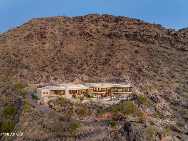 This is your exclusive invitation to explore an architecturally captivating estate nestled high above Paradise Valley. Set within a gated enclave, this residence delivers privacy, luxury, and unmatched desert scenery. With premium finishes and breathtaking views throughout, it’s a must-see home for discerning buyers.
