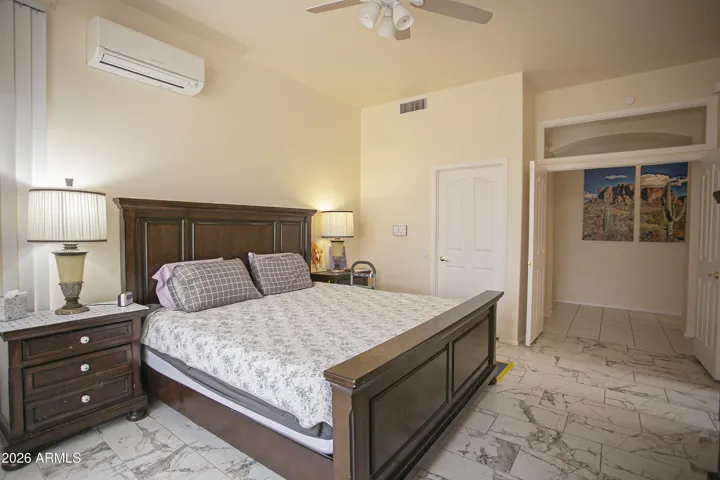 The second closet is next to the bed in this photo