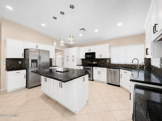 Kitchen and table area with open layout, natural light, and clear connection to surrounding living spaces.