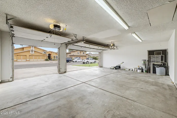 Extra-deep three-car garage providing ample space for vehicles, storage, and workspace.