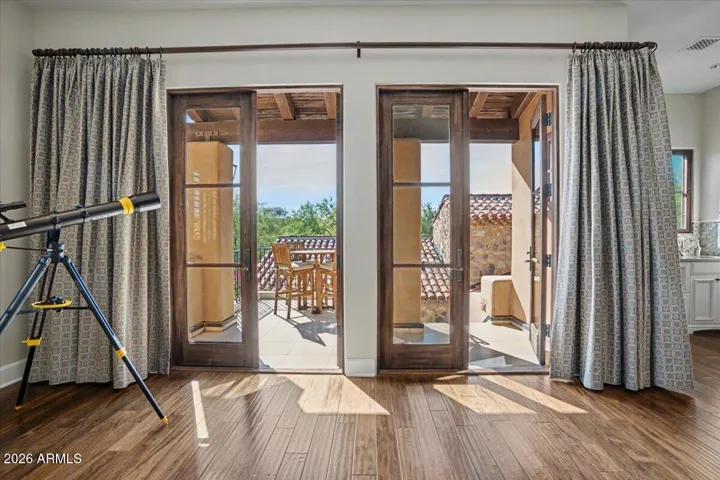 Large patio space off the upstairs bonus room with double French doors for indoor/outdoor living!