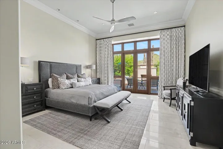 French doors off the primary bedroom lead to the backyard fireplace and pool/spa
