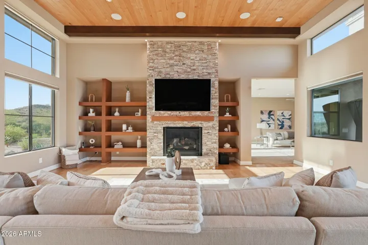 Custom built ins and gas fireplace and an abundance of natural light