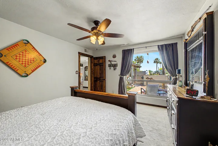 Guest bedroom with picture window overlooking the front courtyard