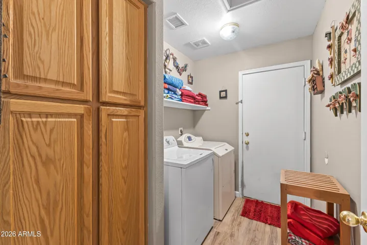 Laundry room with washer & dryer and storage cabinets