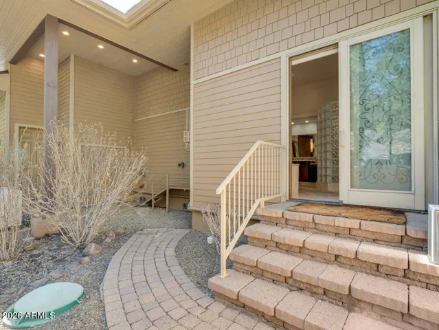 Convenient outdoor dog run area with paver walkways, private access, and low-maintenance landscaping designed for easy living in Flagstaff.