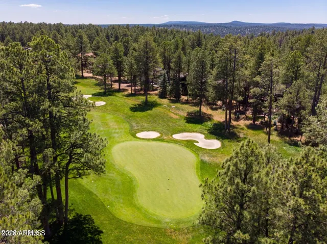 Spectacular aerial views of the golf course featuring lush fairways, manicured greens, and breathtaking natural surroundings in Flagstaff.