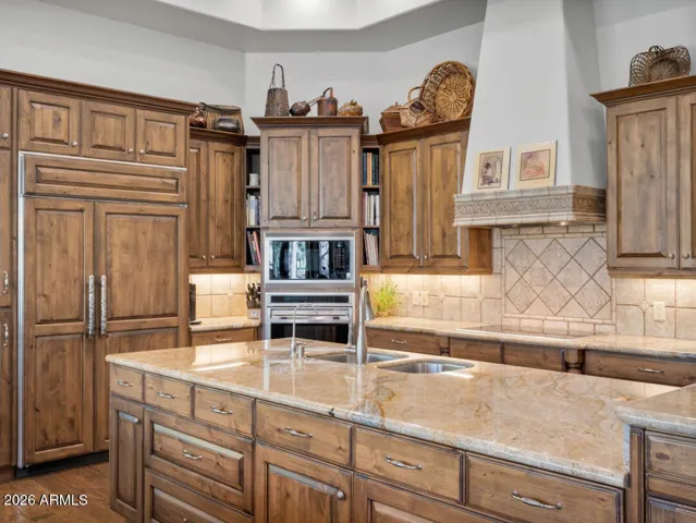 Luxury chef’s kitchen featuring custom wood cabinetry, double ovens, oversized island, and premium finishes designed for elegant entertaining and everyday living in Flagstaff.