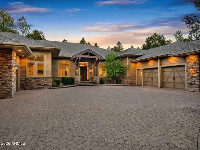 Stunning luxury estate in Forest Highlands featuring timeless mountain architecture, expansive paver driveway, and a premier acre-plus homesite overlooking the Meadow Golf Course in Flagstaff.