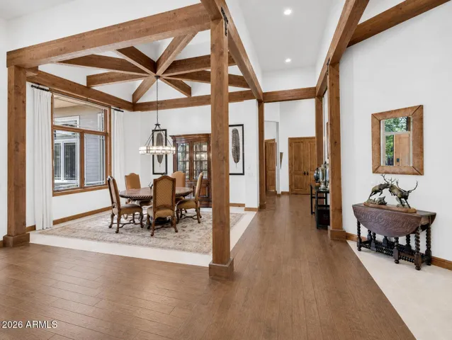 Sophisticated formal dining room with exposed wood beams, warm natural finishes, and elegant mountain-inspired design perfect for entertaining guests in Flagstaff.