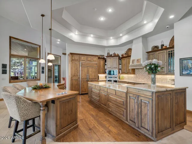 Chef-inspired kitchen featuring dual islands, custom wood cabinetry, premium appliances, and open-concept living spaces designed for luxury entertaining and everyday comfort.