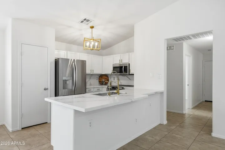 Breakfast bar with quartz counter. Pantry storage.