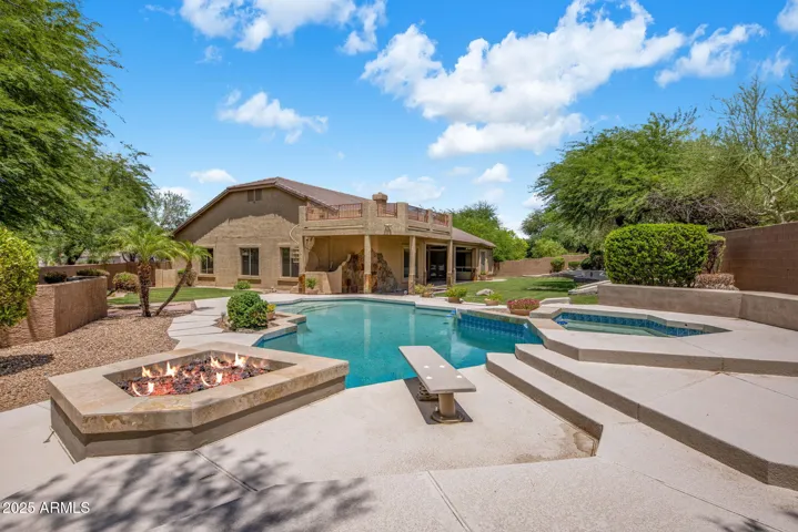 Luxurious diving pool with firepit, spa, and lounging area