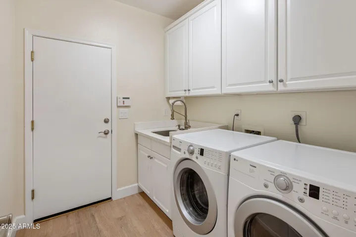 Laundry with utility sink and built-in cabinetry