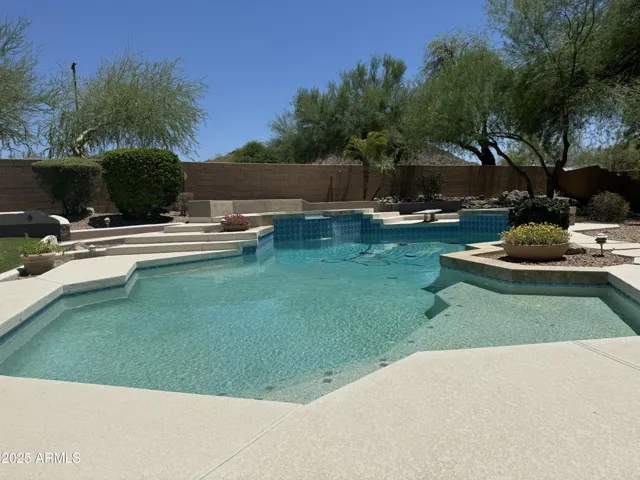 Luxurious diving pool with firepit, spa, and lounging area