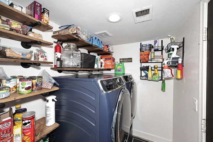 Note the personally designed wood and iron shelving